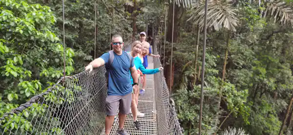 Naturalist guide pointing out camouflaged wildlife in the La Fortuna rainforest