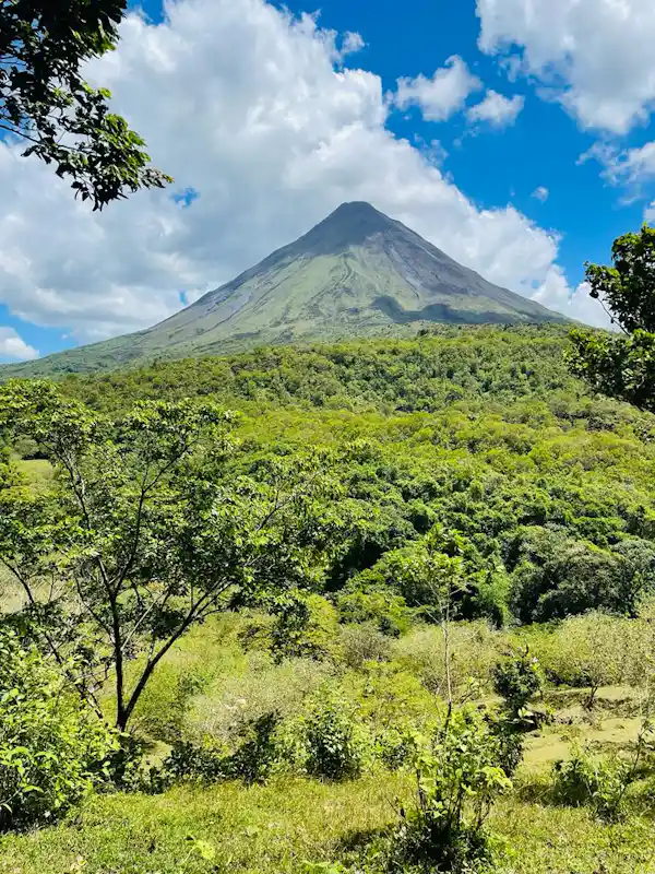 Hikers enjoying the impressive views of Lake Arenal from the top of the lava flow trail