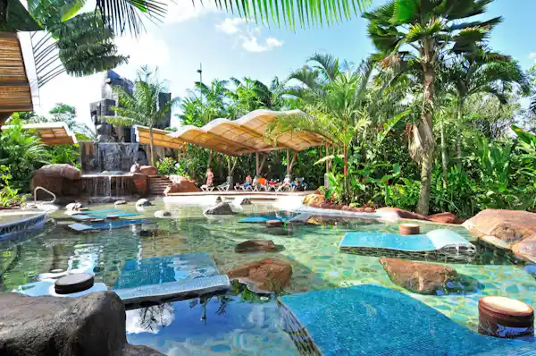 Natural thermal hot springs pools with a direct view of the Arenal Volcano at Baldi Hot Springs Resort