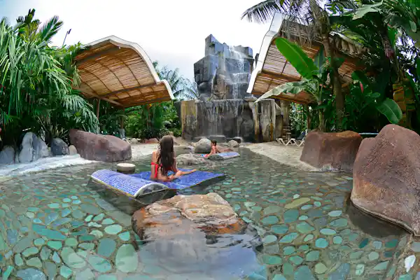 Immersive rainforest jungle path and relaxation area inside the Baldi Hot Springs grounds in La Fortuna